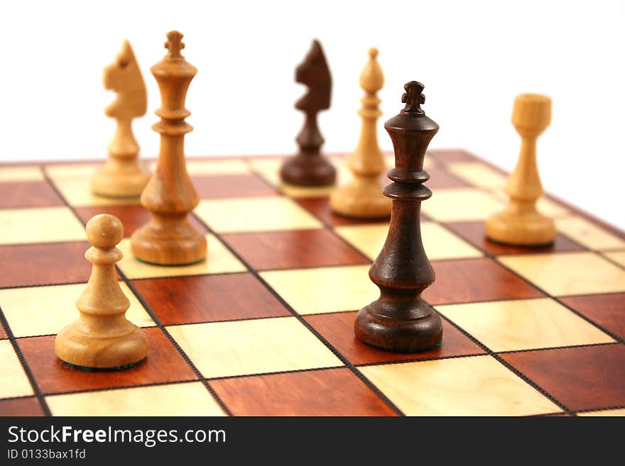 Wooden chess on wooden chessboard in studio