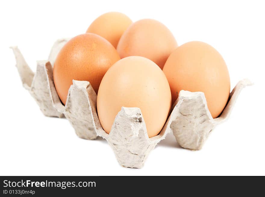 Five eggs in cartons cell. Brown. Isolated on a white background. Five eggs in cartons cell. Brown. Isolated on a white background.