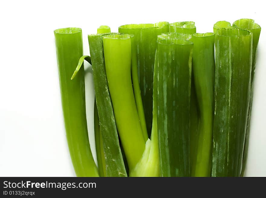 Stack of fresh green onions sprouts on a white background. Stack of fresh green onions sprouts on a white background.