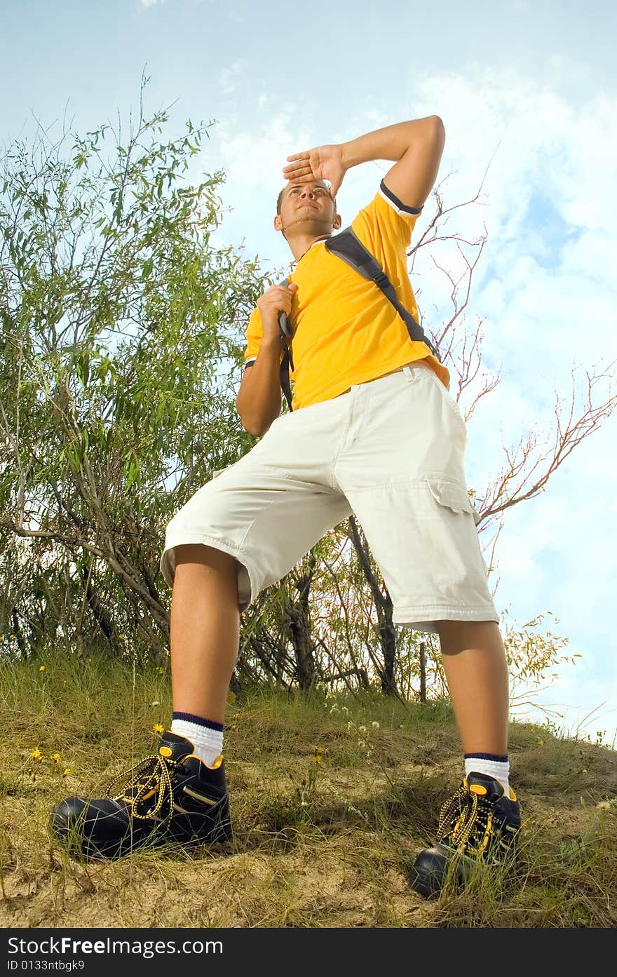 Young man hiker on the hill