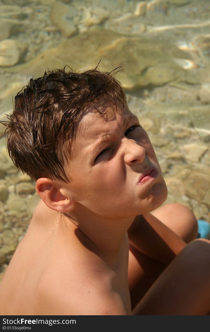 Boy on a beach ready to swim. Boy on a beach ready to swim