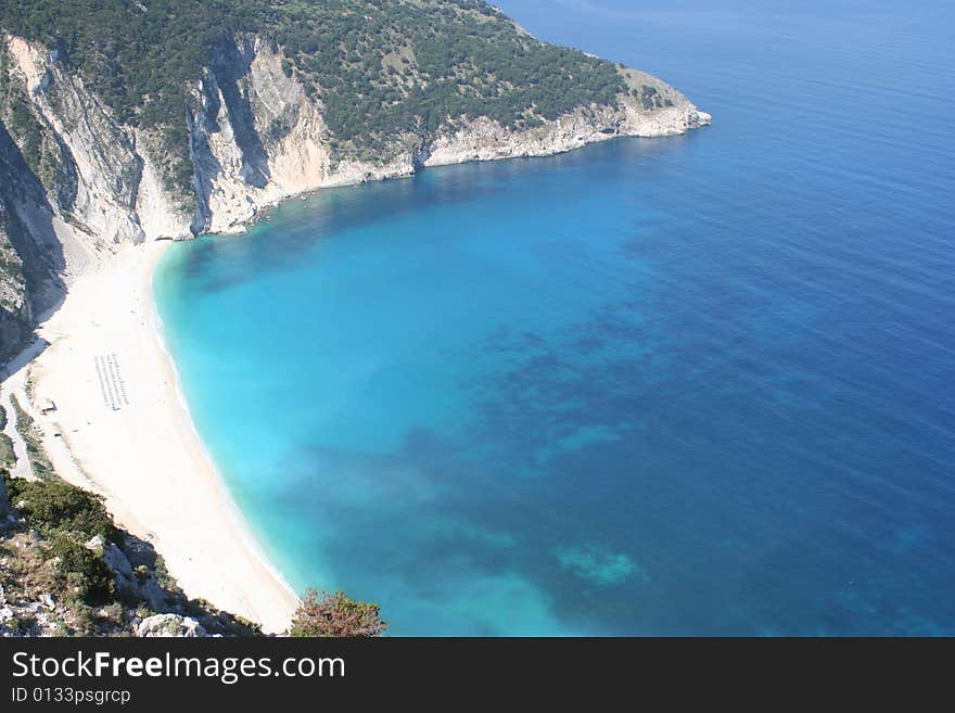 An high viewpoint image of a bright white sandy beach in Greece. An high viewpoint image of a bright white sandy beach in Greece.