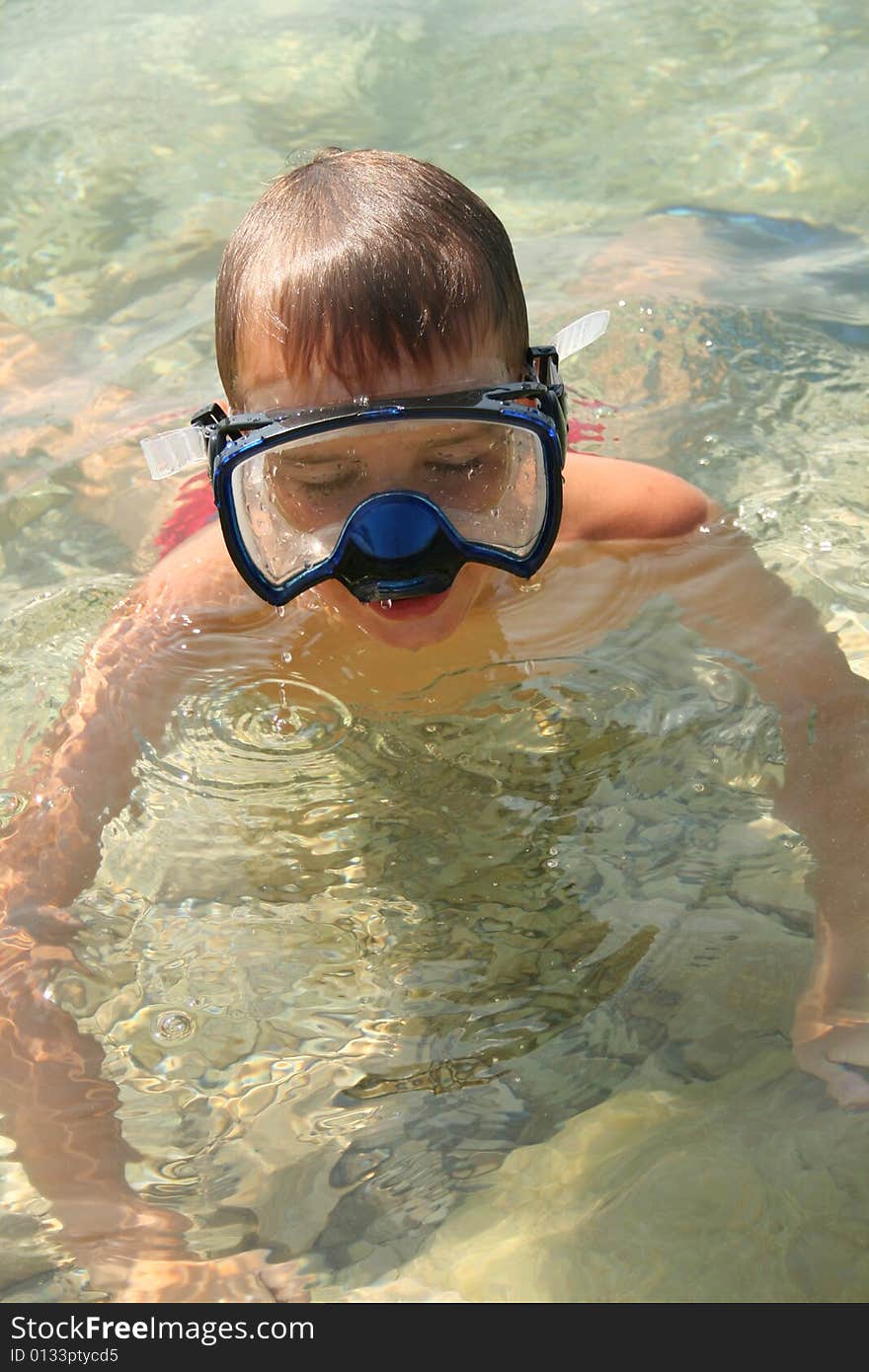 Boy on a beach ready to swim. Boy on a beach ready to swim