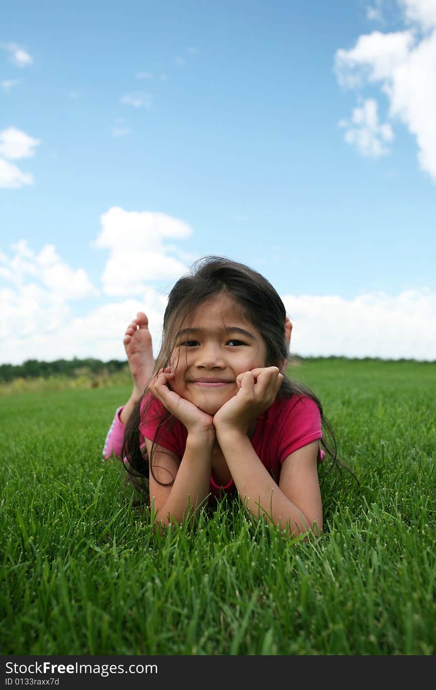 Little Girl Lying On Grass