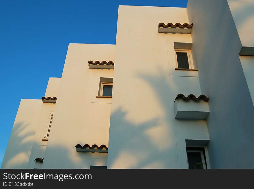 White building, window 
against the blue sky