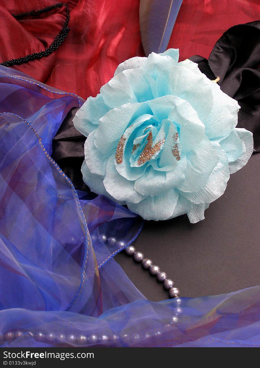 Paper rose from blue color with coloured textiles and grey pearls. Paper rose from blue color with coloured textiles and grey pearls.