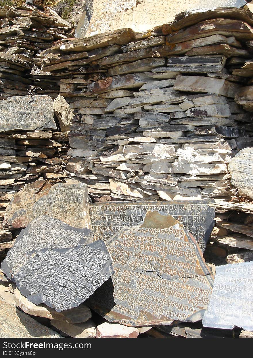 Nepali people write holy text on stones. Nepal, April 2008