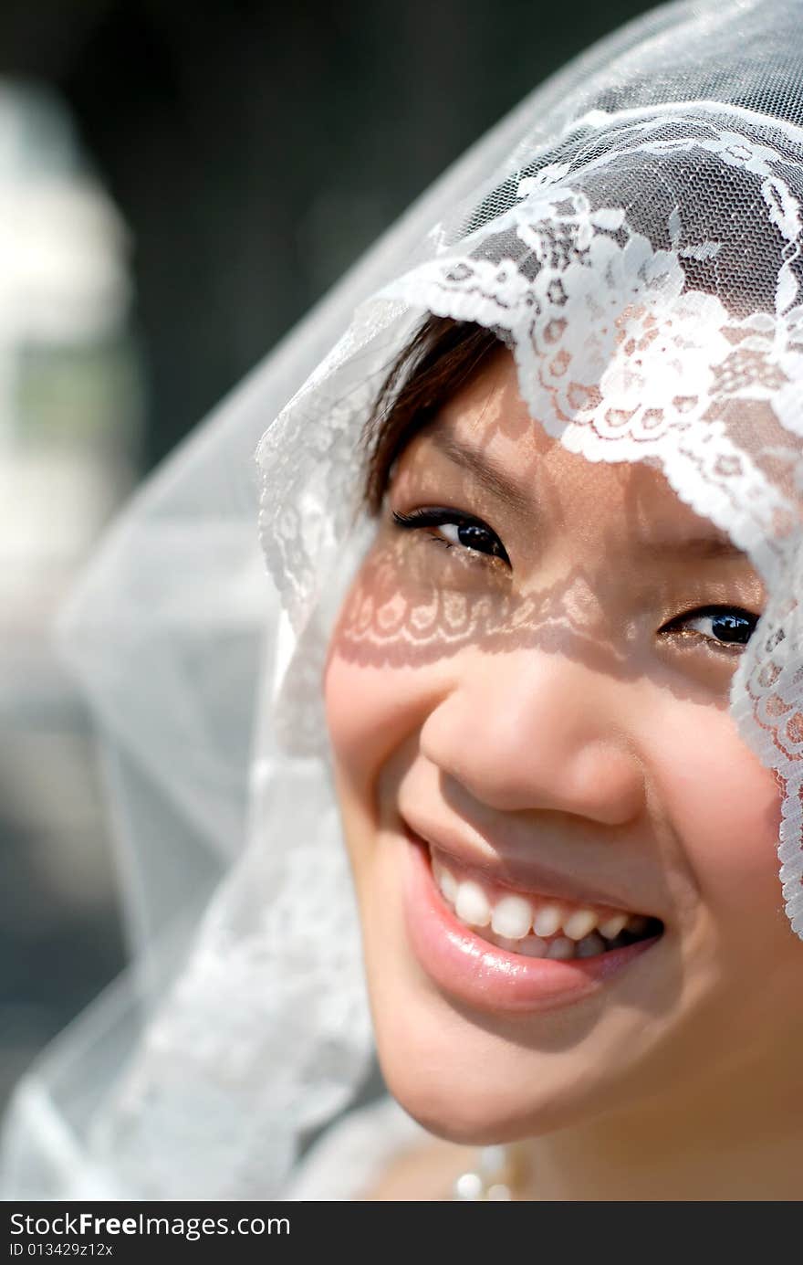 happy bride close up veil over face Portrait  asian  in white wedding wear. happy bride close up veil over face Portrait  asian  in white wedding wear