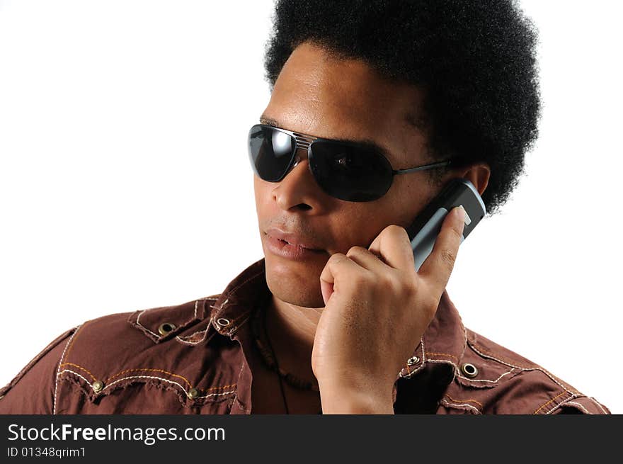 Portrait of young trendy african man using a cell phone - isolated. Portrait of young trendy african man using a cell phone - isolated