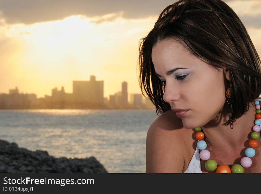 Portrait of young fashionable woman relaxing at sunset - havana skyline on the background. Portrait of young fashionable woman relaxing at sunset - havana skyline on the background