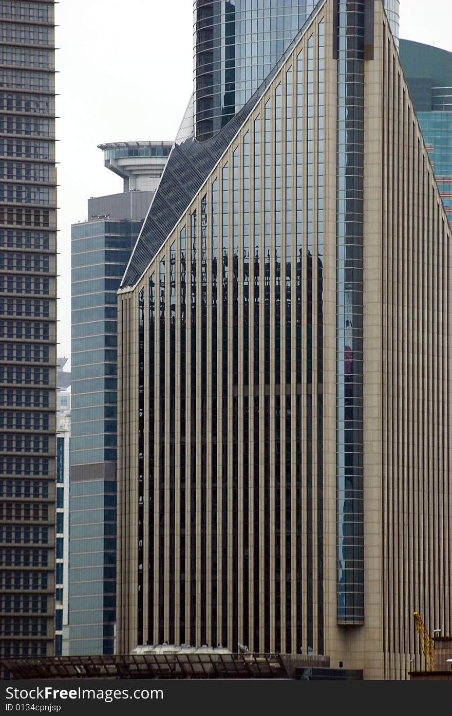 Shanghai, modern skyscrapers - closeup photo showing building structure and original design. Shanghai, modern skyscrapers - closeup photo showing building structure and original design.