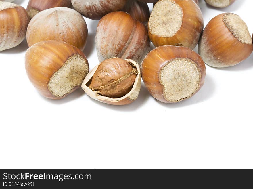 Hazel nuts  with cracked one over white background