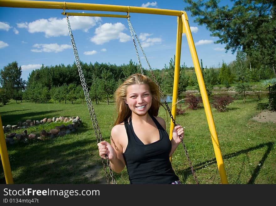 The girl on a yellow seesaw. The girl on a yellow seesaw