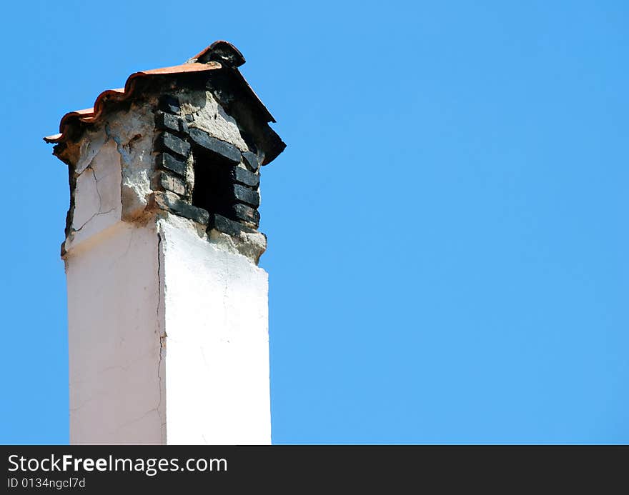 Old smoky chimney isolated over blue sky. Old smoky chimney isolated over blue sky