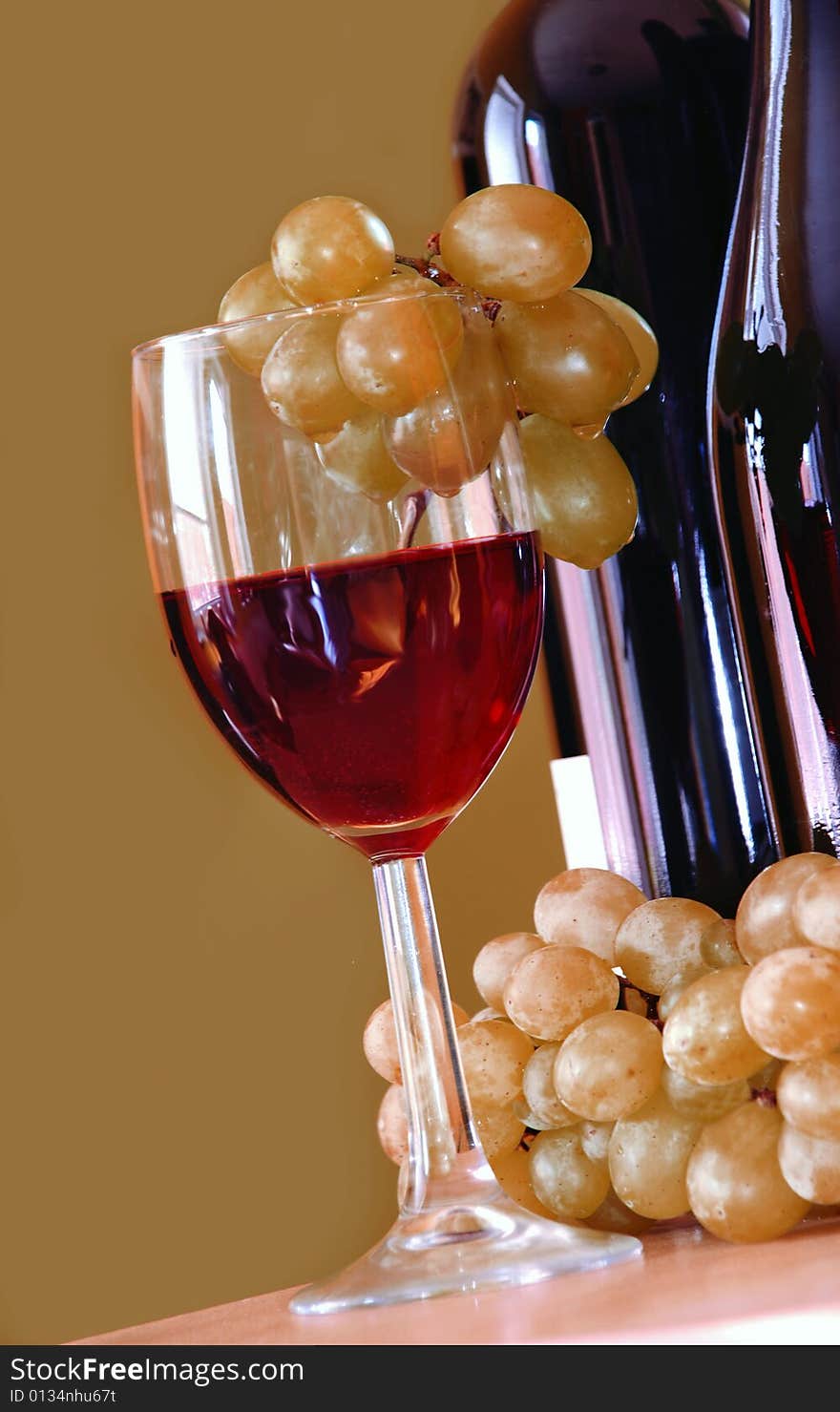 Red wine glass with grapes cluster and bottle. Red wine glass with grapes cluster and bottle