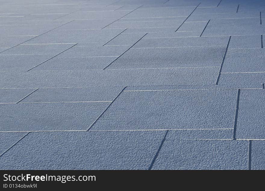 Abstract, perspective pattern of blueish grey stone tiles. Sharpness drops towards the back of the photo. Abstract, perspective pattern of blueish grey stone tiles. Sharpness drops towards the back of the photo.