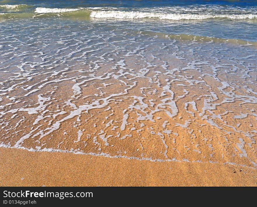 Golden beach with just some waves at the North Sea. Golden beach with just some waves at the North Sea