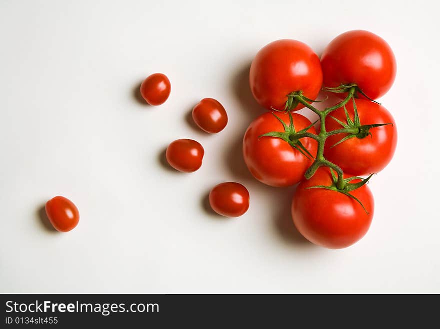 Big and cherry tomatoes on paper