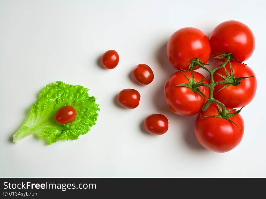 Big and cherry tomatoes on paper