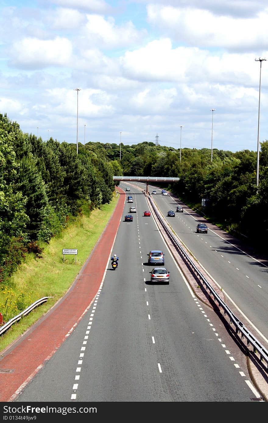 A busy road photograph on a sunny day