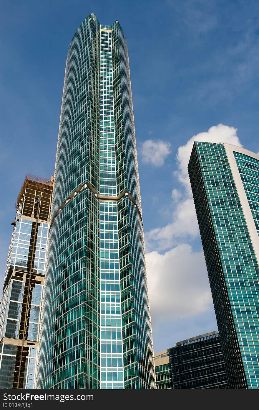 Beautiful skyscrapers on a background of the blue sky with clouds. Beautiful skyscrapers on a background of the blue sky with clouds