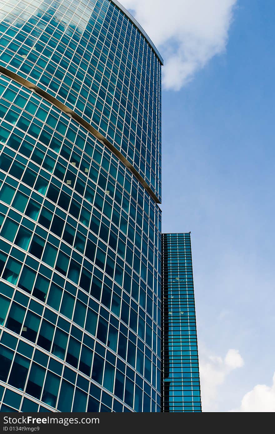 Corporate building in beautiful perspective against dynamic partially clouded sky. Corporate building in beautiful perspective against dynamic partially clouded sky