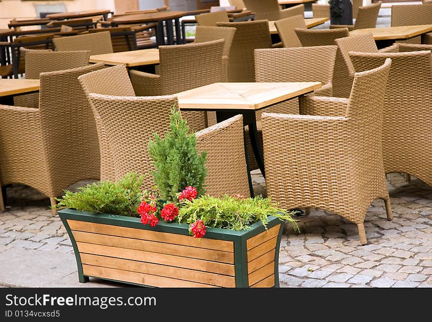 Comfortable willow chairs and wooden tables outside a restaurant. Comfortable willow chairs and wooden tables outside a restaurant