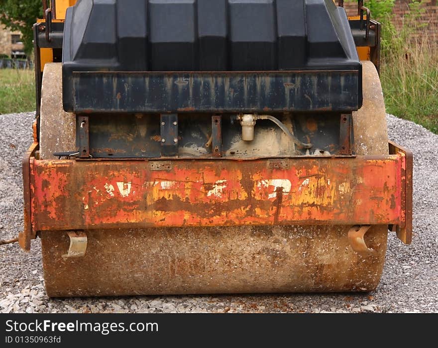 Front of an old, rusted, beat up, steamroller.