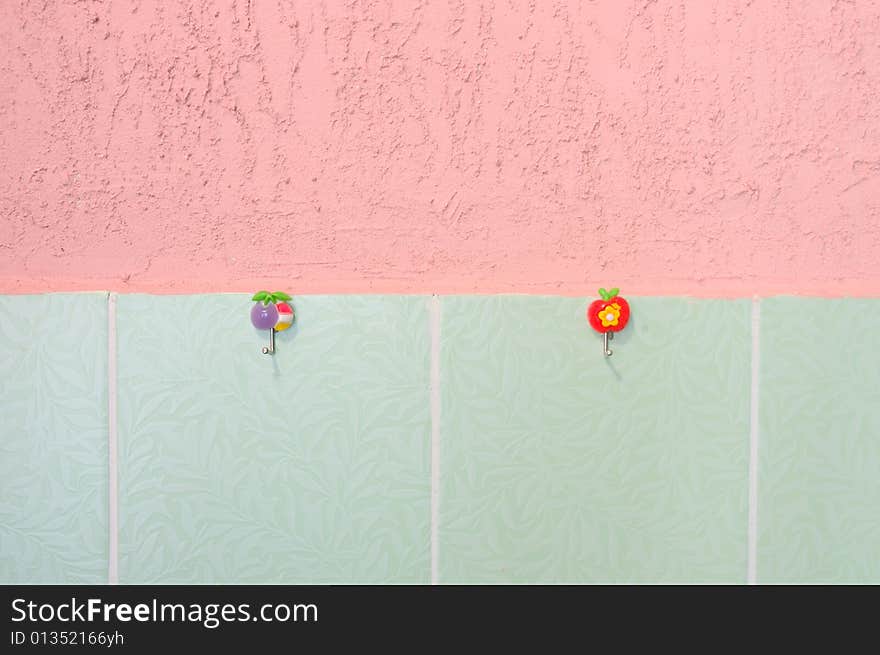 Pink stucco and green tiled wall. With hooks.