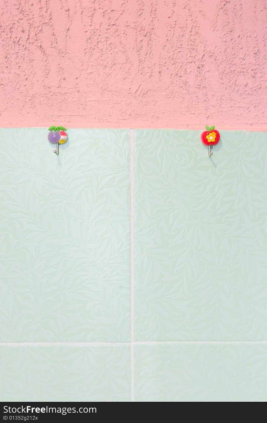 Pink stucco and green tiled wall. With hooks.