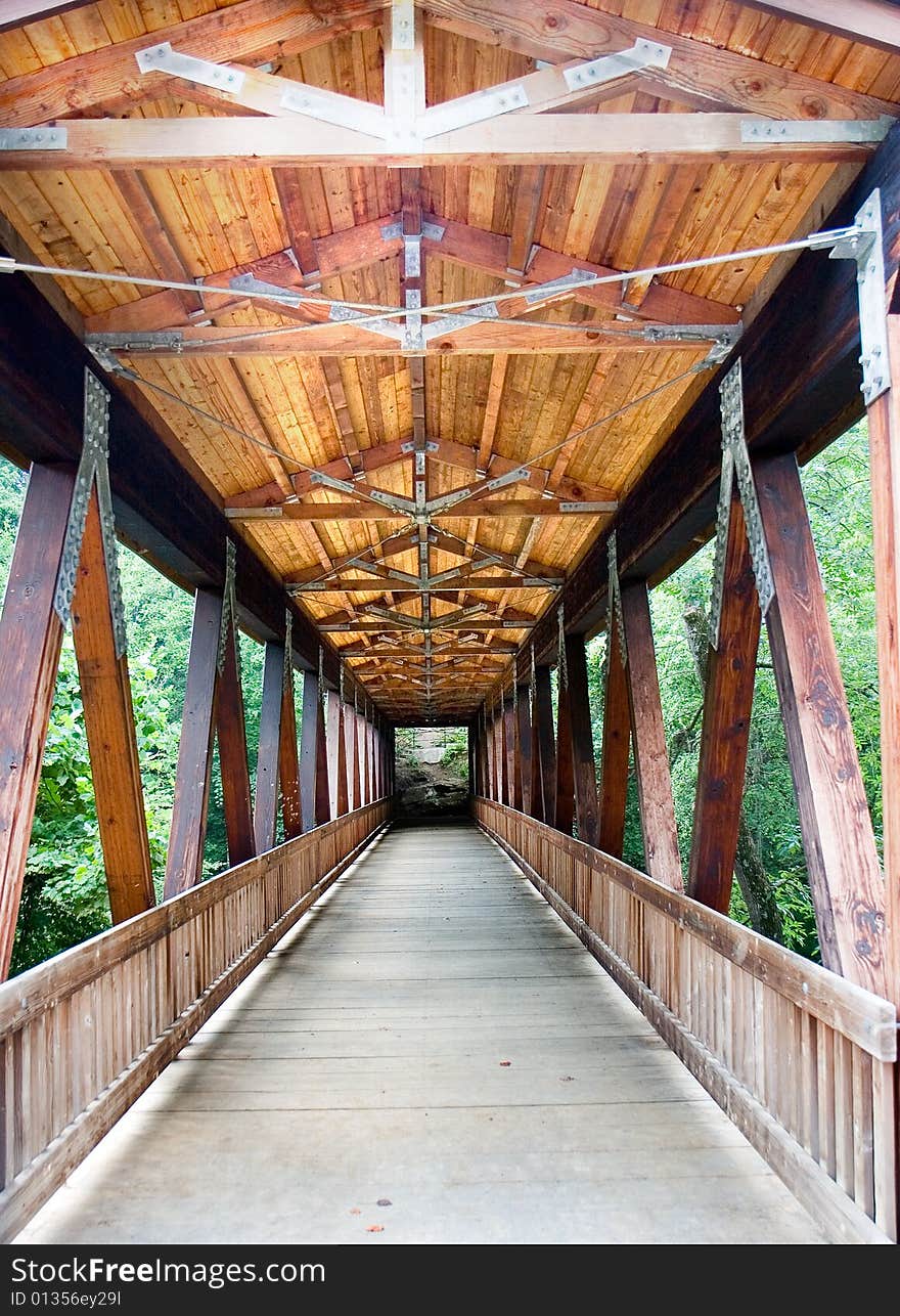 An old wood covered bridge over a river. An old wood covered bridge over a river