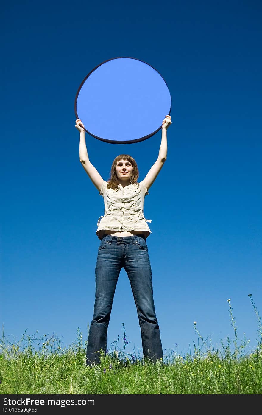 The girl in the field with dark blue circle over a head (place for an inscription). The girl in the field with dark blue circle over a head (place for an inscription)