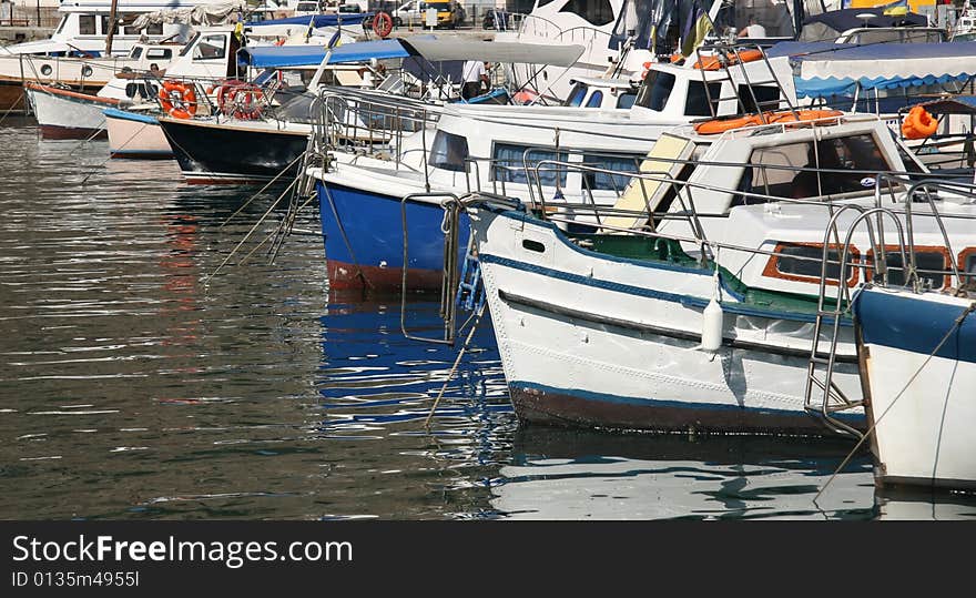 An image of boats and yachts reflecting in water