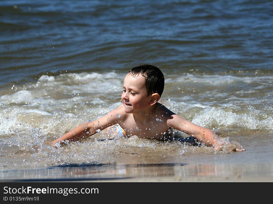 4 years old boy playing in the sea. 4 years old boy playing in the sea