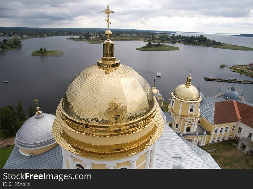 Gold domes of orthodox church in a monastery of Nil Stolbenskij, Island Stolbnyj, lake Seliger, near Ostashkov, Russia, view from a belltower. Gold domes of orthodox church in a monastery of Nil Stolbenskij, Island Stolbnyj, lake Seliger, near Ostashkov, Russia, view from a belltower