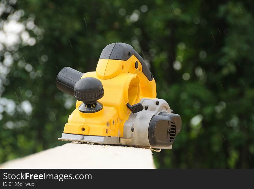 The modern yellow electric planer. The modern yellow electric planer