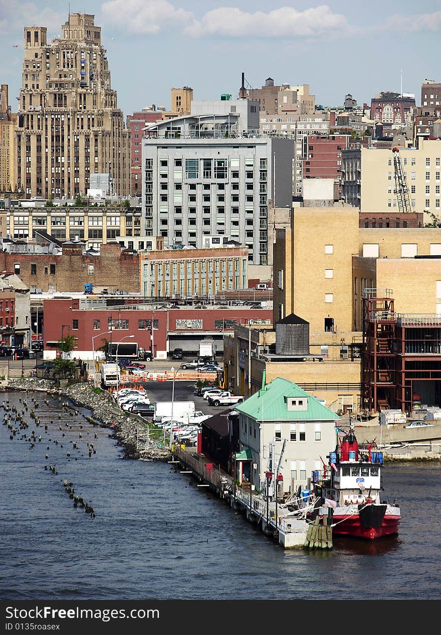 The view of the small pier with Manhattan landmark in a background (New York City). The view of the small pier with Manhattan landmark in a background (New York City).