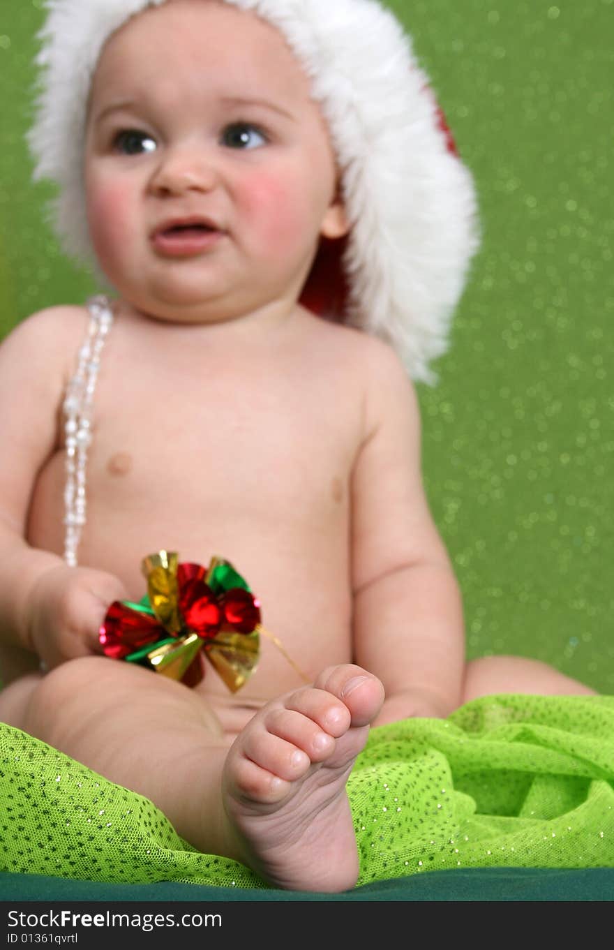 Christmas Baby playing with decorations.  FOCUS on Foot