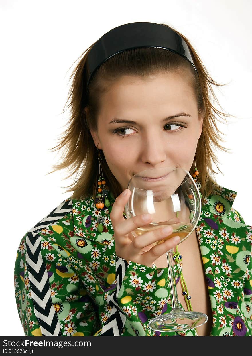 Young thoughtful woman with glass of white wine and in green coat with flowers is looking one's right side. Young thoughtful woman with glass of white wine and in green coat with flowers is looking one's right side.