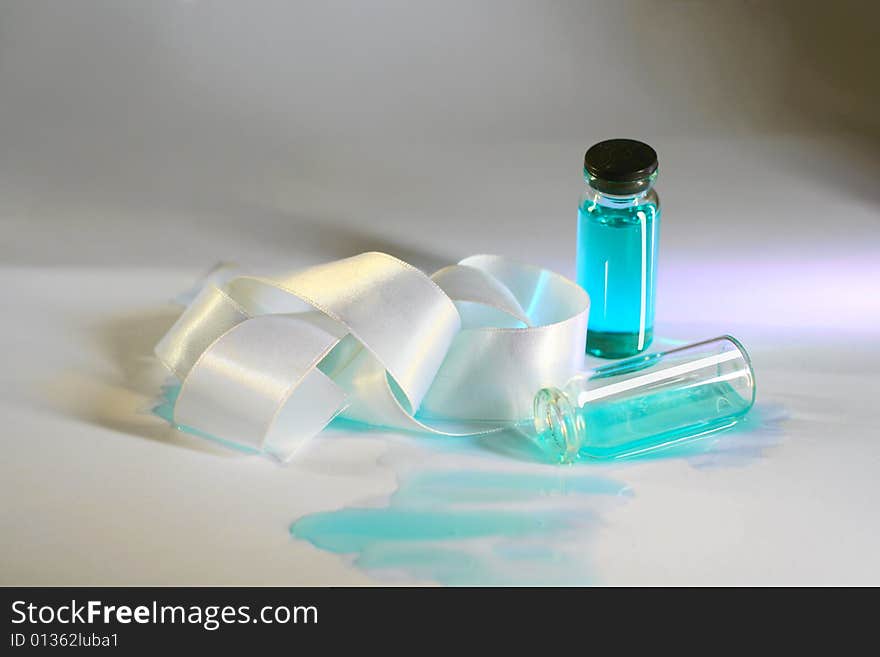 Two measuring glasses with blue liquid