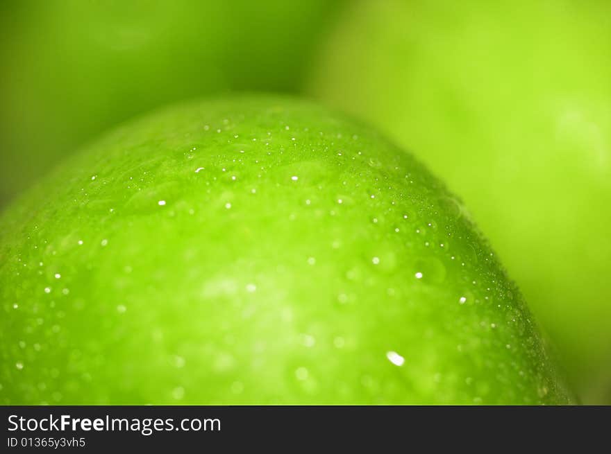 Close-up green apple with waterdrops