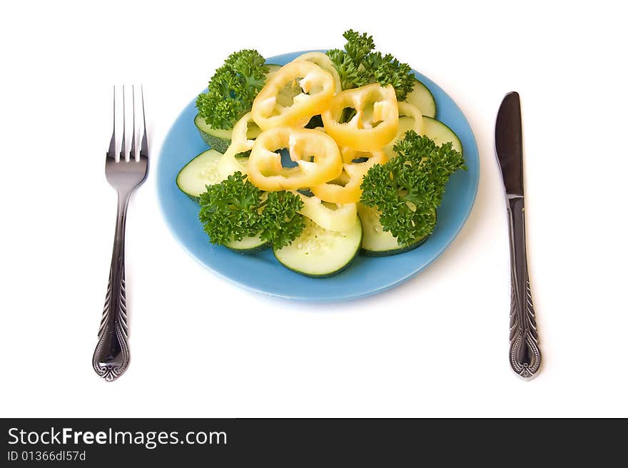 A photo of blue plate, vegetables on it and covers near it. A photo of blue plate, vegetables on it and covers near it