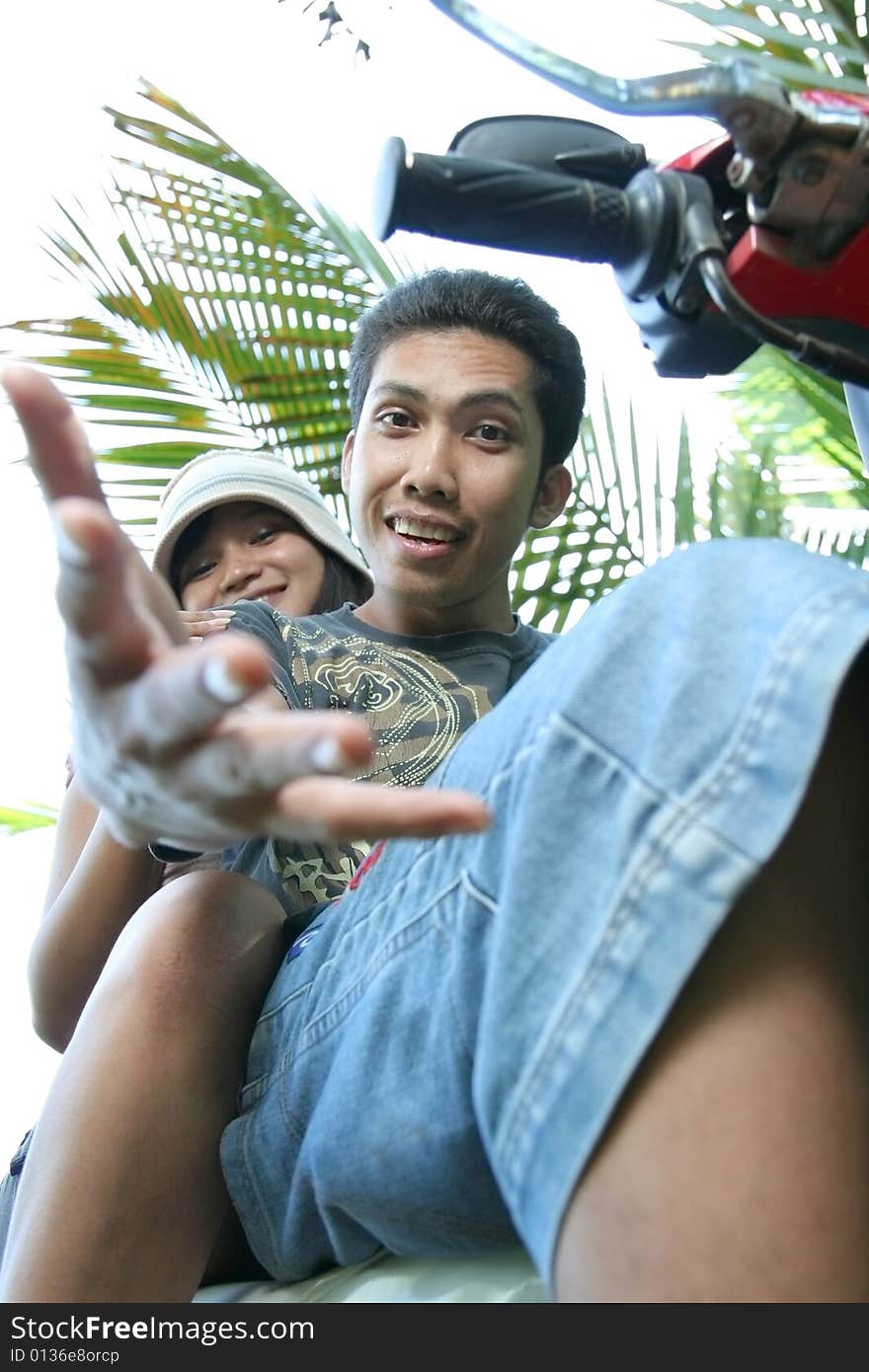 Asian couple fun on bike in nature