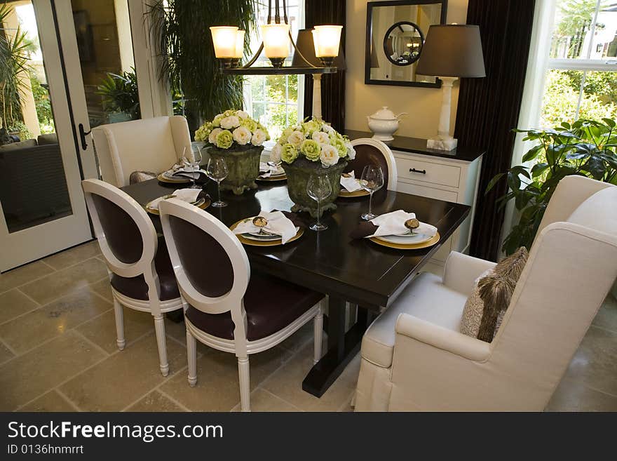 Dining room with modern tableware and decor. Dining room with modern tableware and decor.