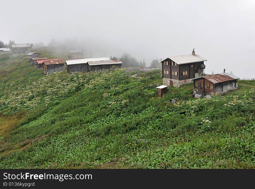 View of old houses street on green mountainside. View of old houses street on green mountainside.