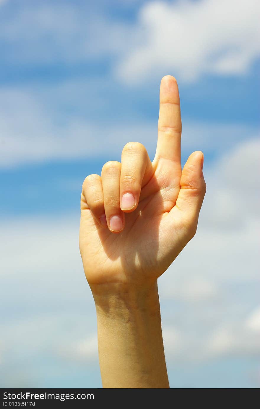 Hand pointing with index finger against a white background