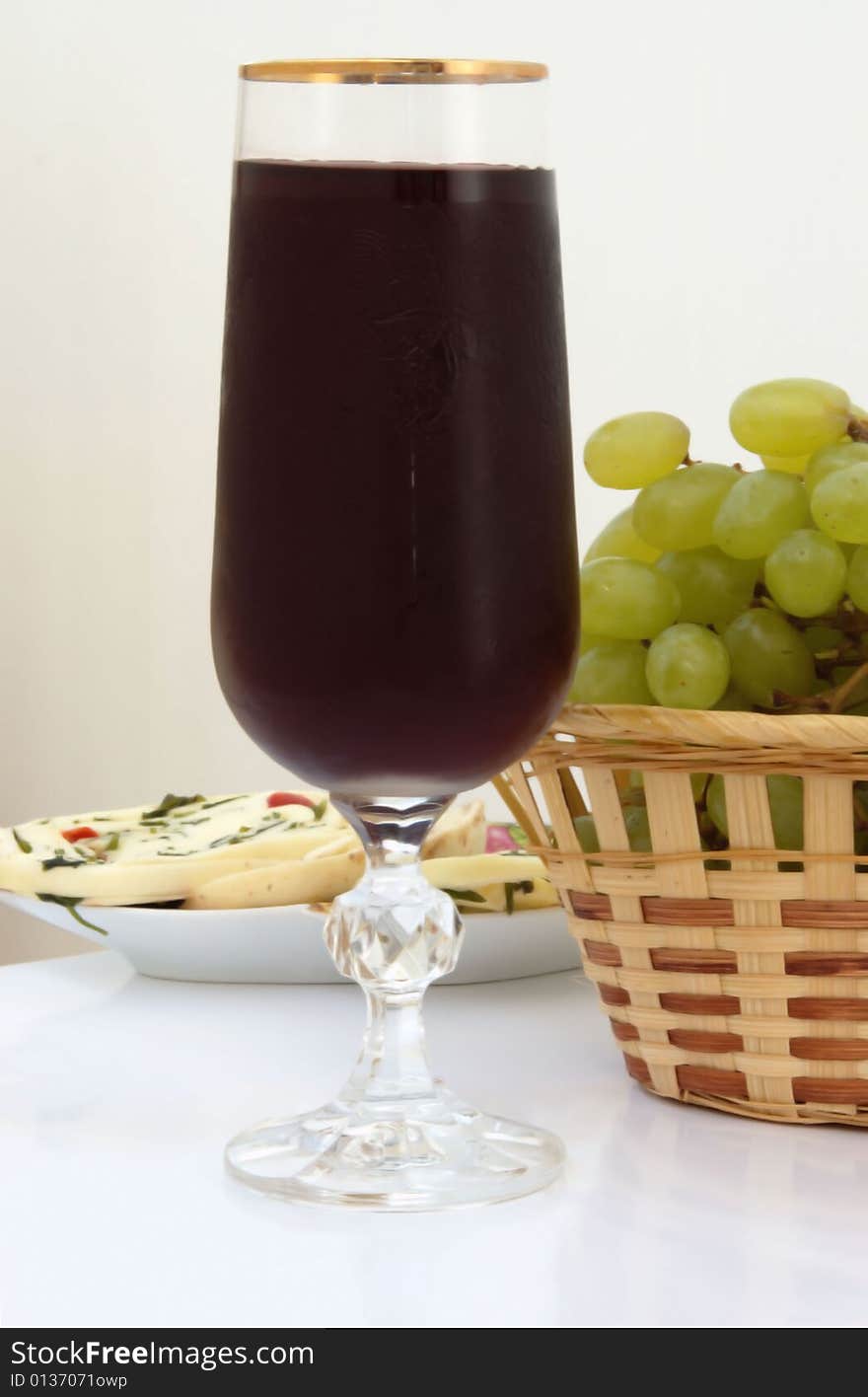 Red wine in glass with white grape