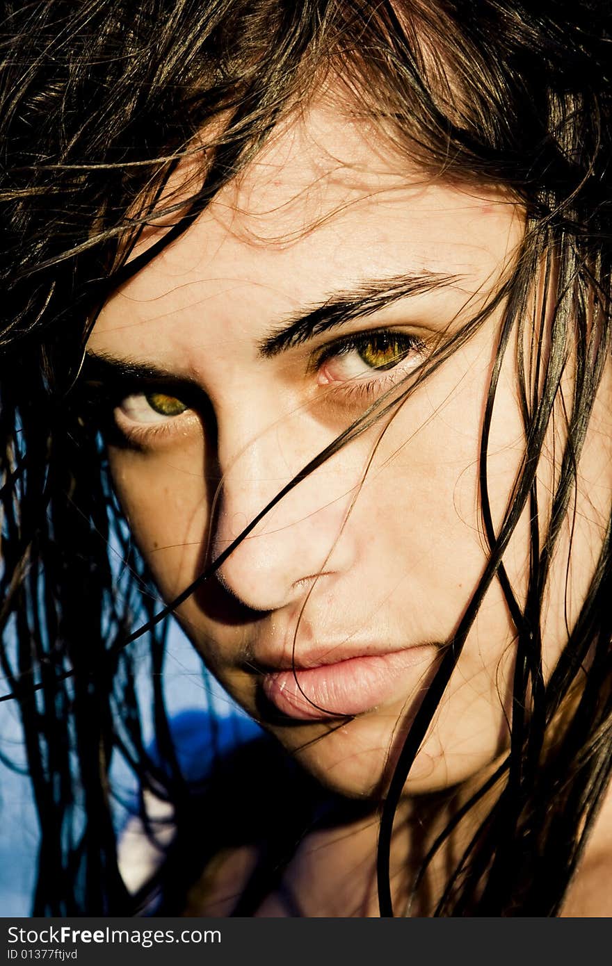 Beautiful green eyed woman portrait with wet hair.