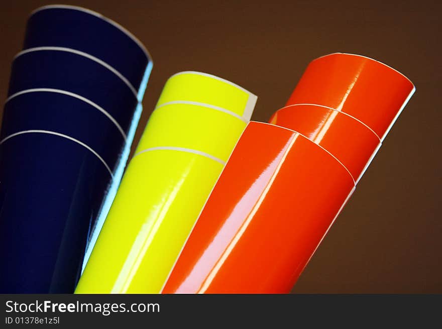 The set of three shiny decorating foils over dark background