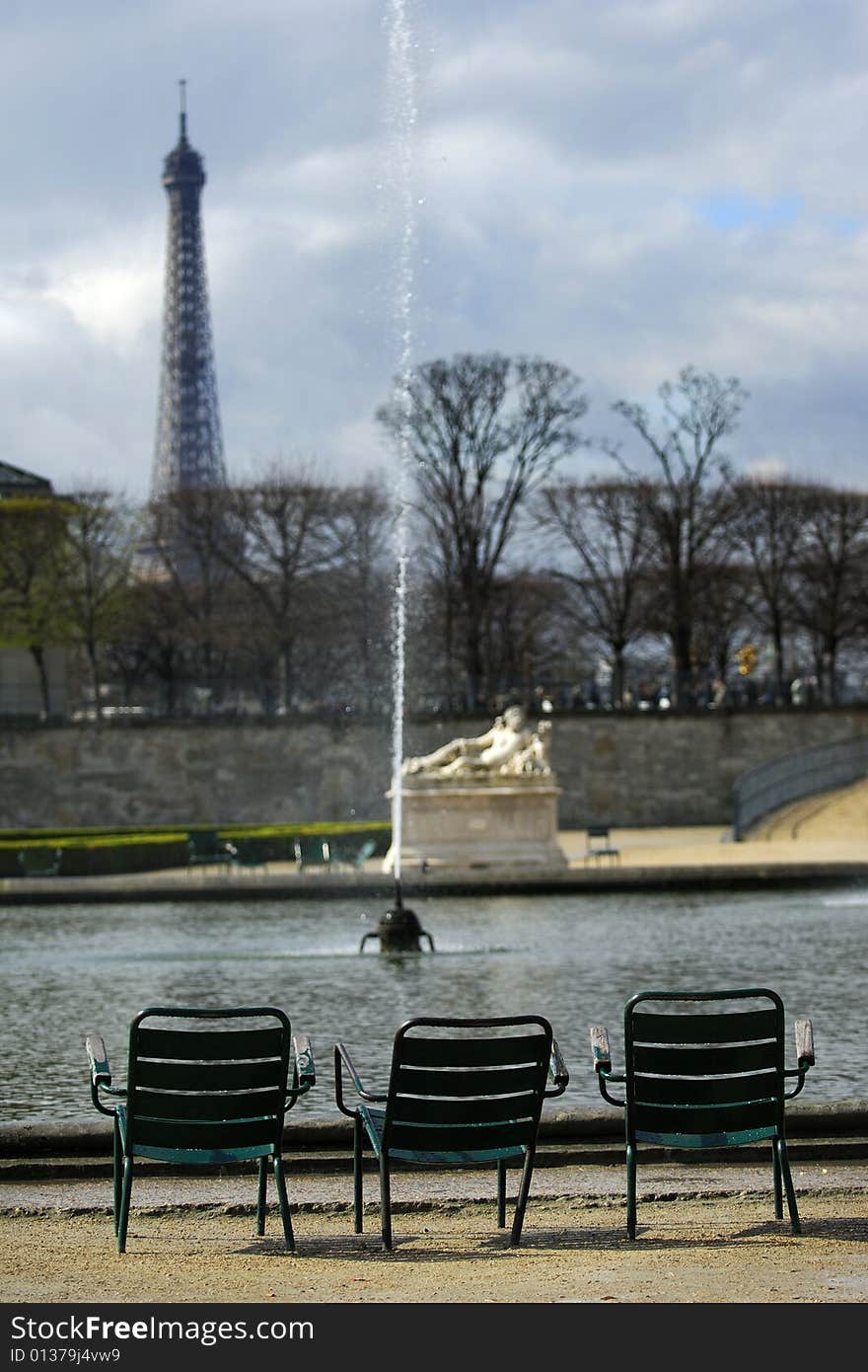 A lonely, empty chairs in the Tuileries Garden, facing the Eiffel Tower